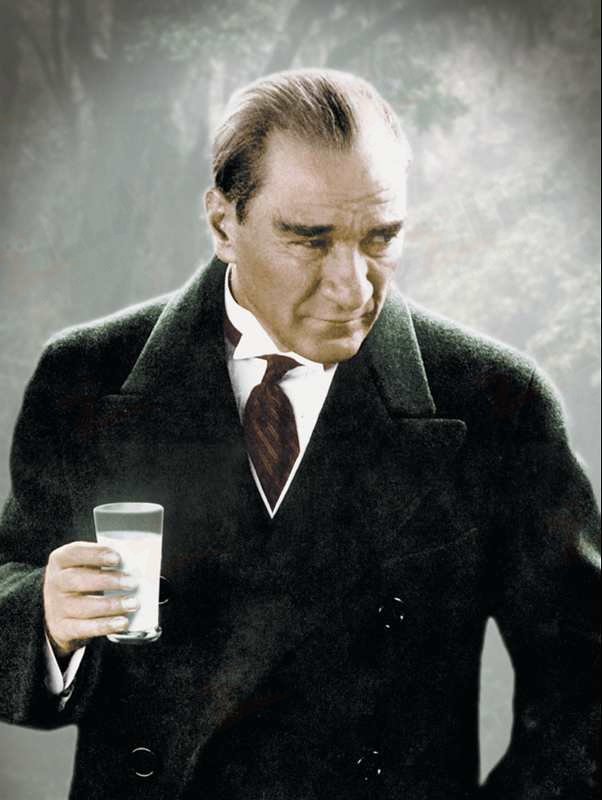 Atatürk in a common pose with a full glass of Turkish raki.