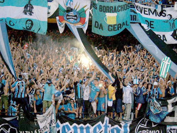 These are fans from Gremio (Brazil). One of their fanclubs is named 'Borrachos da Geral', which means the drunks of the general.