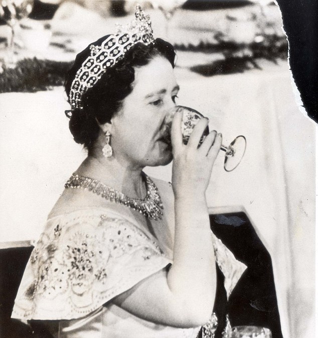 The Queen Mother Elizabeth in a classic pose as she sips on a glass of wine.